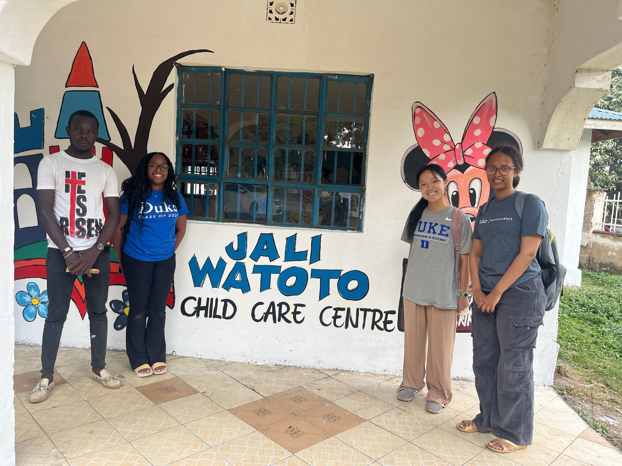 Team and volunteers at Jali Watoto Child Care Centre entrance